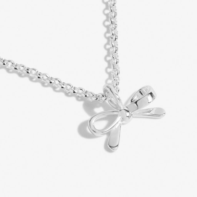 Our A Little Thank You Necklace features an elegant silver-plated chain and a sparkling bow charm. Perfectly presented on one of our signature stylised cards and framed by a sweet sentiment. This piece was made to be cherished now and for years to come.