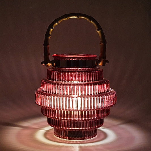 A unique style of lamp that catches your eye with its beautiful glass pattern emphasizing its stacked shape, and its dark red colouring.