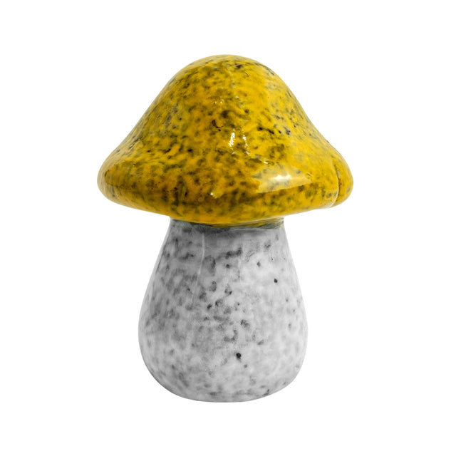 Close-up of yellow porcelain decorative mushroom with earthy glaze and realistic handcrafted stem design