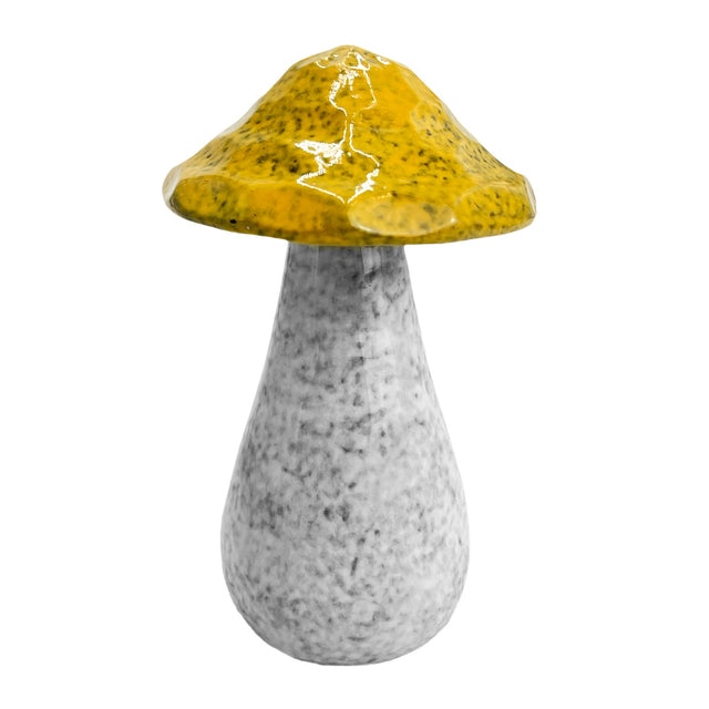 Close-up of large yellow porcelain decorative mushroom with earthy glaze and realistic handcrafted stem design.