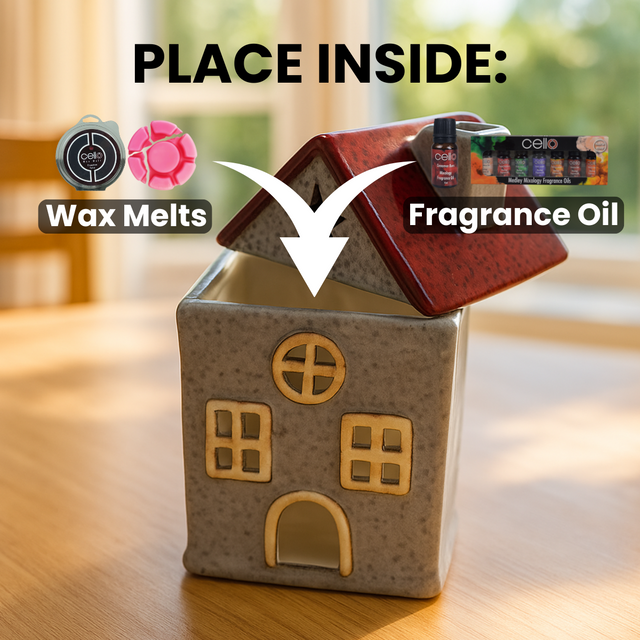 Star Cottage in grey and red ceramic house design shown on table with text highlighting compatibility with wax melts and essential oils or fragrance oils in wax melt burner.