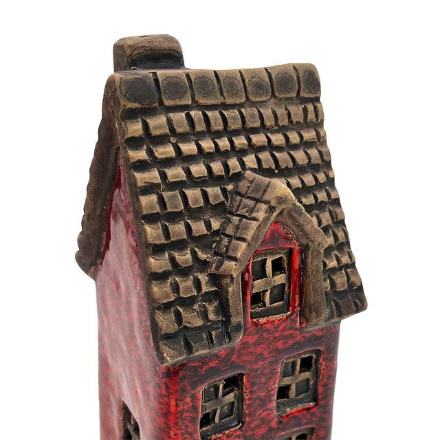 Close-up of the Goldsmith’s Abode ceramic house roof showing textured tiles and fine hand-painted craftsmanship.