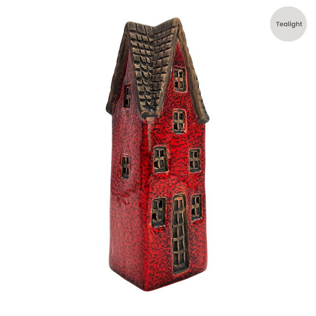 Side view of the second crimson variant of Goldsmith’s Abode ceramic tealight house featuring tall windows and rustic roof detail.
