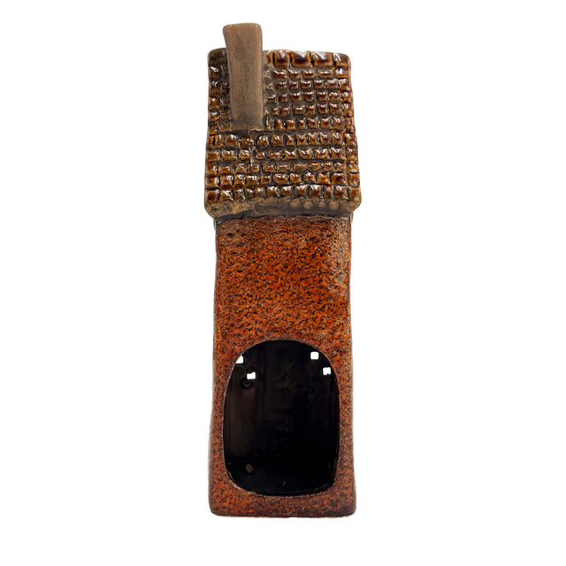 Rear view of the rustic brown Goldsmith’s Abode ceramic tealight holder showing arched tealight opening and roof detail.