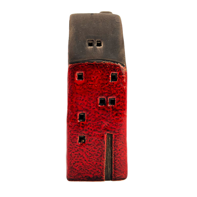 Front view of the Brackenwood Manor red village pottery house with tall windows and smooth ceramic finish under a dark roof.