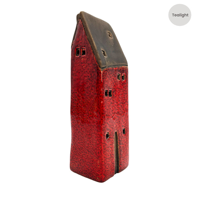 Side angle of the Brackenwood Manor red ceramic tealight house with dark roof and textured red glaze finish.