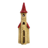 Front view of the Ivory Tower light-up ceramic house featuring tall spire, ivory body, and red roof detail with arched windows.