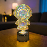 Gleneagles Rotating Gold Bear Battery Lamp glowing softly on a side table in a modern living room, casting a warm infinity light reflection and adding golden ambience to the décor.