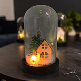 Gleneagles FireGlow LED USB Flame Glass Dome glowing softly on a side table in a cosy living room, creating a warm, flickering light that adds comfort and festive ambience.