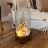 Gleneagles FireGlow Stag LED USB Flame Glass Dome glowing on a side table in a cosy living room, featuring a flickering flame and stag silhouette that adds warm festive ambience and woodland charm.