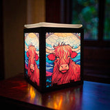 Highland Cow Electric Wax Melt Burner glowing in a cosy home setting, adding warmth and countryside charm to modern décor.