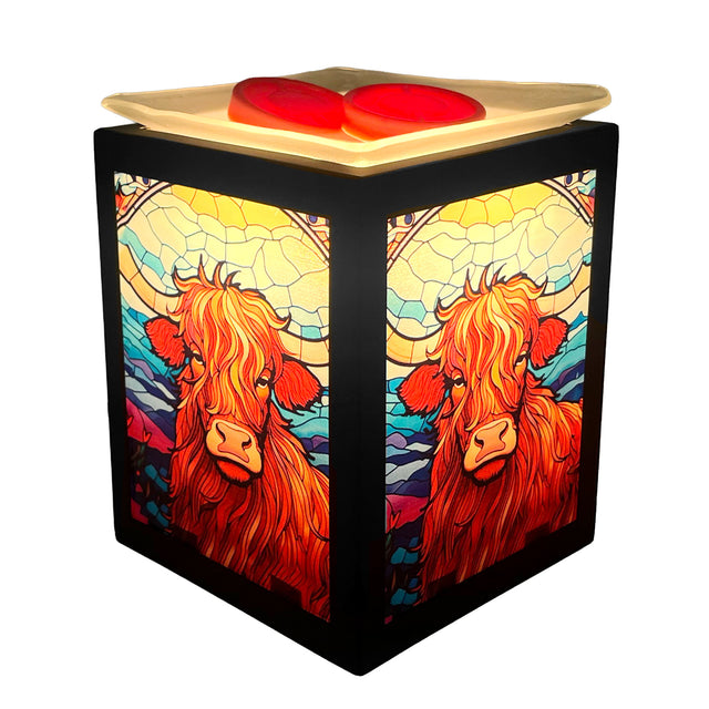 Lit Highland Cow Electric Melt Burner with wax melts inside, emitting soft ambient light and relaxing fragrance.