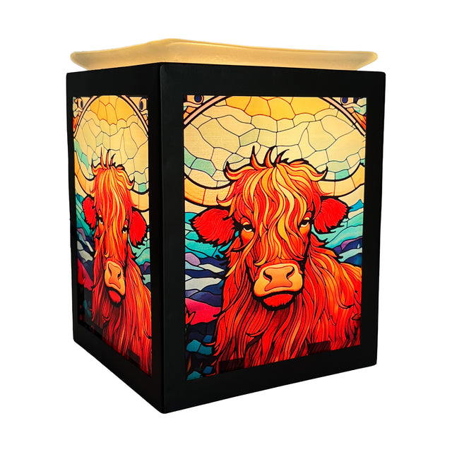 Cello Highland Cow Electric Melt Burner illuminated, showcasing stained-glass-style light and rustic cow design for cosy home fragrance.