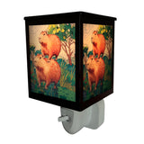 Cello Capybara Plug In Electric Melt Burner illuminated, showcasing stained-glass-style light and rustic capybara design for cosy home fragrance