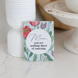 ceramic magnet with floral design and message 'Mum, you are nothing short of amazing' on a marble surface as unique gift for mother's day