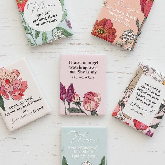 Collection of floral-themed ceramic magnets with messages for mum on a white surface  as unique gift for mother's day