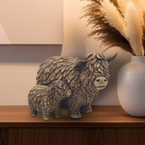 Resin Highland Cow & Calf ornament displayed on a sideboard with rustic décor, adding warmth and countryside charm to the living room.