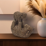 Resin Highland Cow & Calf ornament displayed on a sideboard with rustic décor, adding warmth and countryside charm to the living room.