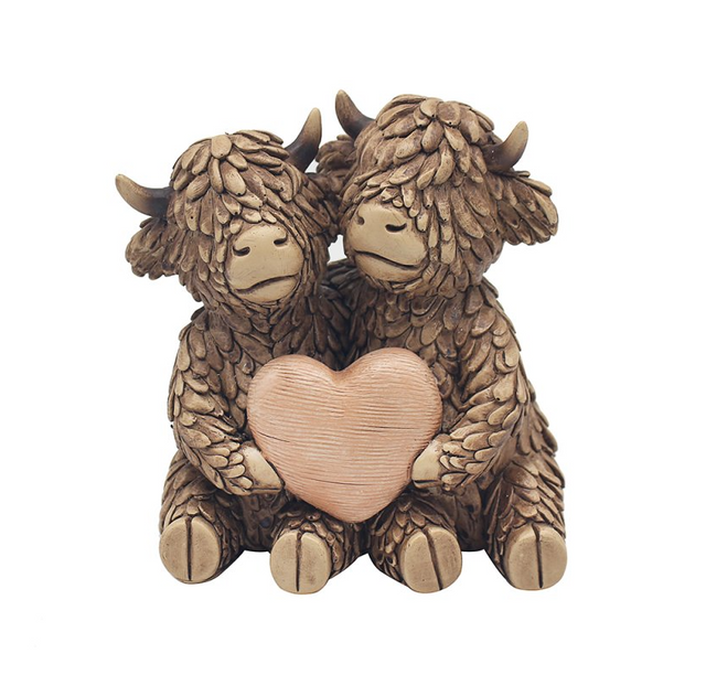 True Love Hughie Highland Cows holding heart and ornament made from hand-painted resin, featuring detailed fur texture in natural brown tones – Highland cow ornament by Lesser & Pavey.
