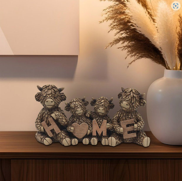 Resin Highland Cow Family Home ornament displayed on a sideboard with rustic décor, adding warmth and countryside charm to the living room.