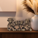 Resin Highland Cow Family Love ornament displayed on a sideboard with rustic décor, adding warmth and countryside charm to the living room.