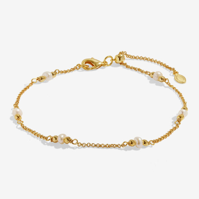 Adjustable gold anklet with pearl accents