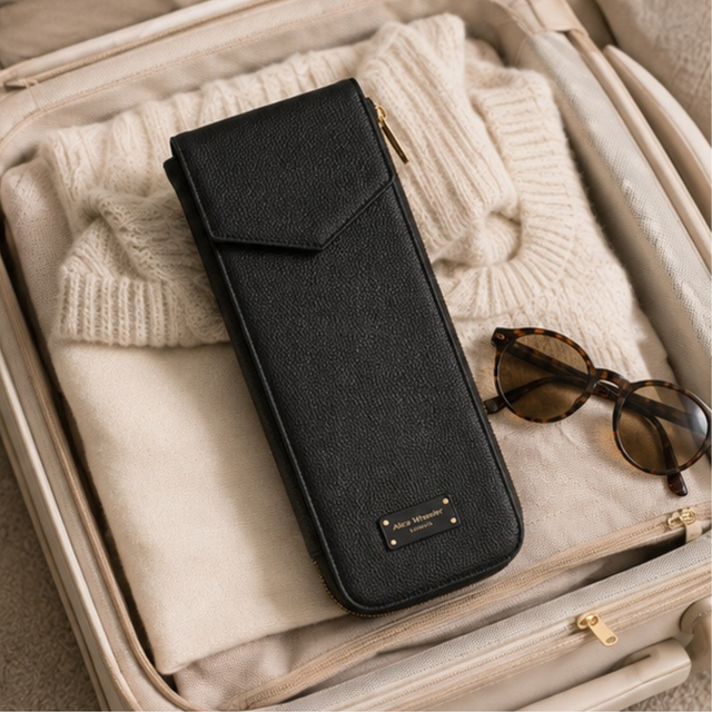 Alice Wheeler Black heat-resistant straightener pouch styled with hair and beauty essentials