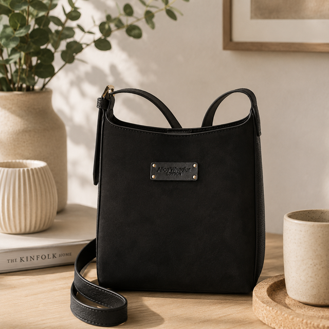 Alice Wheeler Black Mini Bag showing suede finish and signature branding