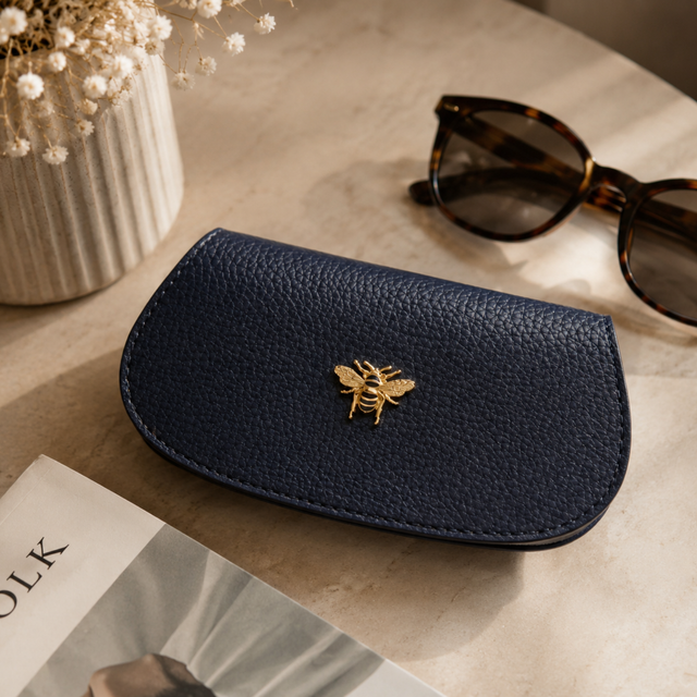 Alice Wheeler Navy Glasses Case showing textured finish and gold bee emblem
