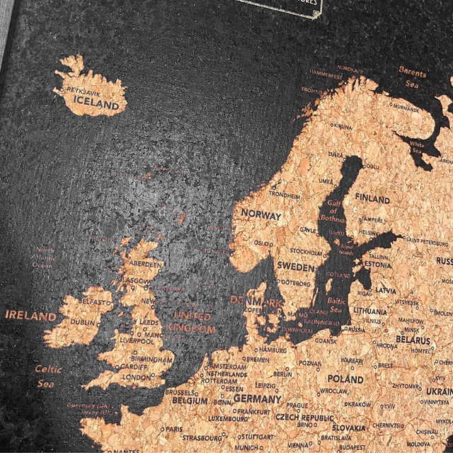 Europe travel map cork board detail with gold and silver pins