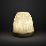 Cello tall tealight dome with illuminated elephant design on dark background.