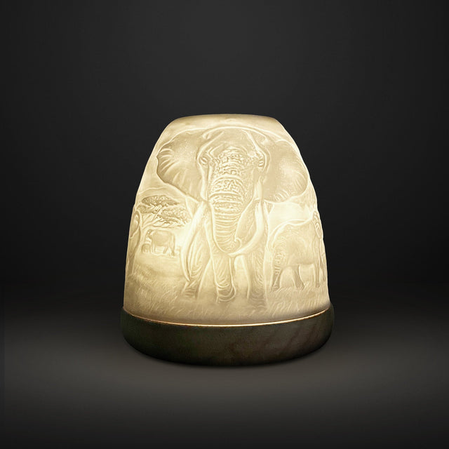Cello tall tealight dome with illuminated elephant design on dark background.