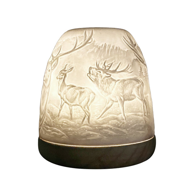 Highland Stag porcelain tealight dome shown from side angle illuminated