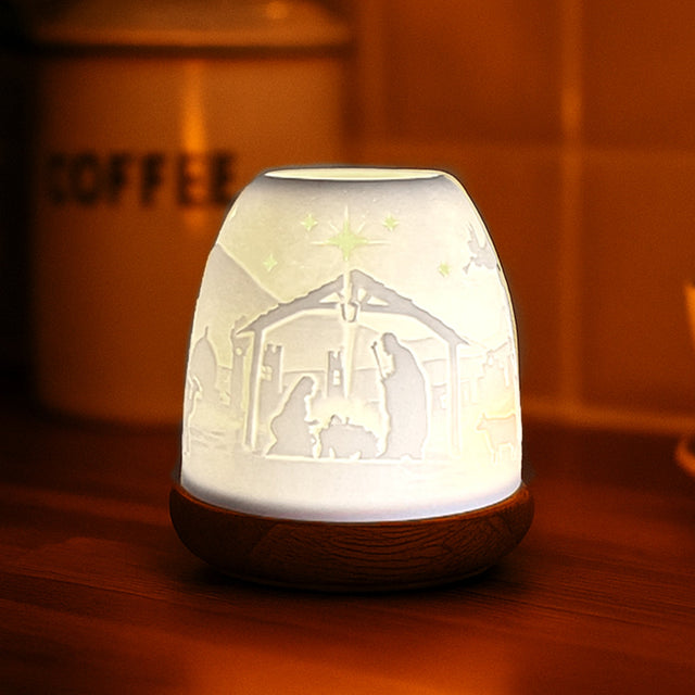 Porcelain Nativity tealight dome illuminated with warm candlelight