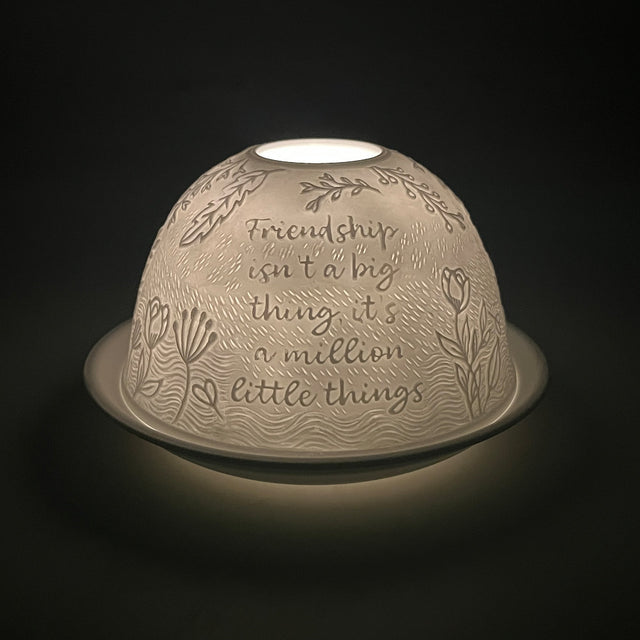 Side angle view of the Cello Tealight Dome Best Best Friend illuminated to reveal detailed porcelain design.