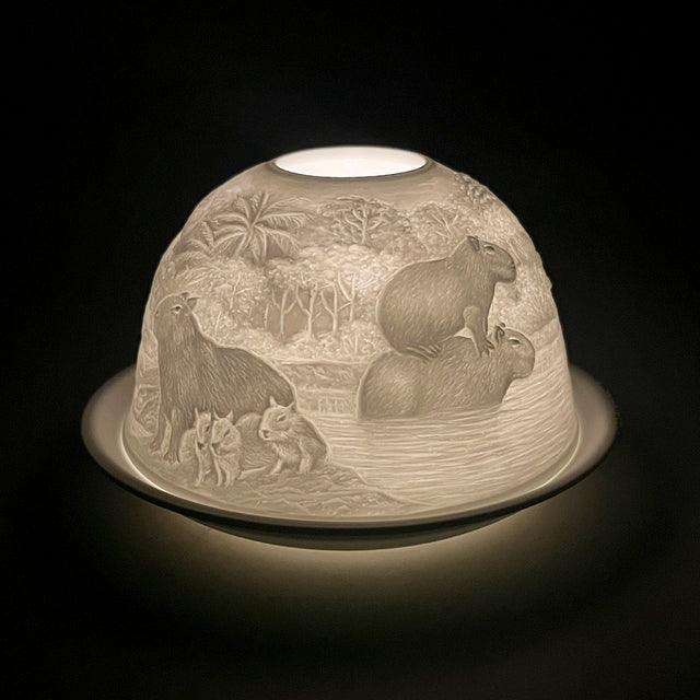 Cello porcelain tealight dome with capybara design illuminated from the front.