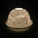 Side view of the Cello capybara porcelain tealight dome glowing softly.