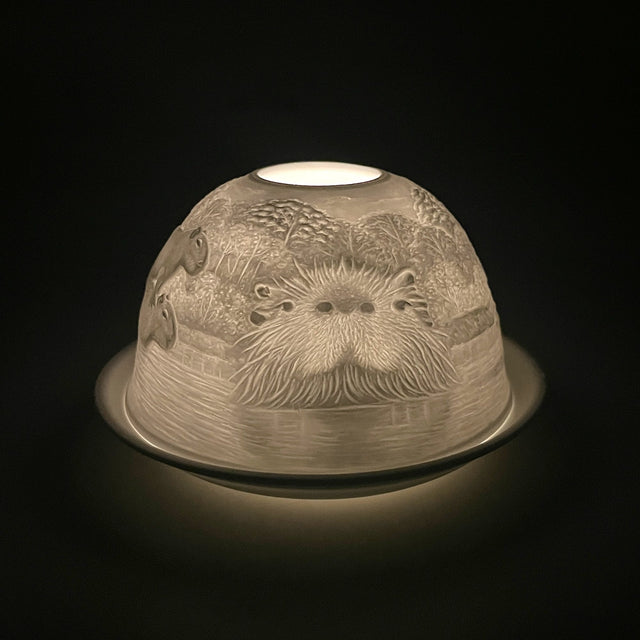 Capybara lithophane tealight dome by Cello glowing in a dark setting.