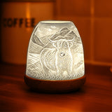 Highland Cow porcelain tealight dome illuminated with warm ambient lighting