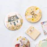 Splosh Cottage Grove Light Cottage ceramic coaster displayed with other ceramic coasters in the collection.
