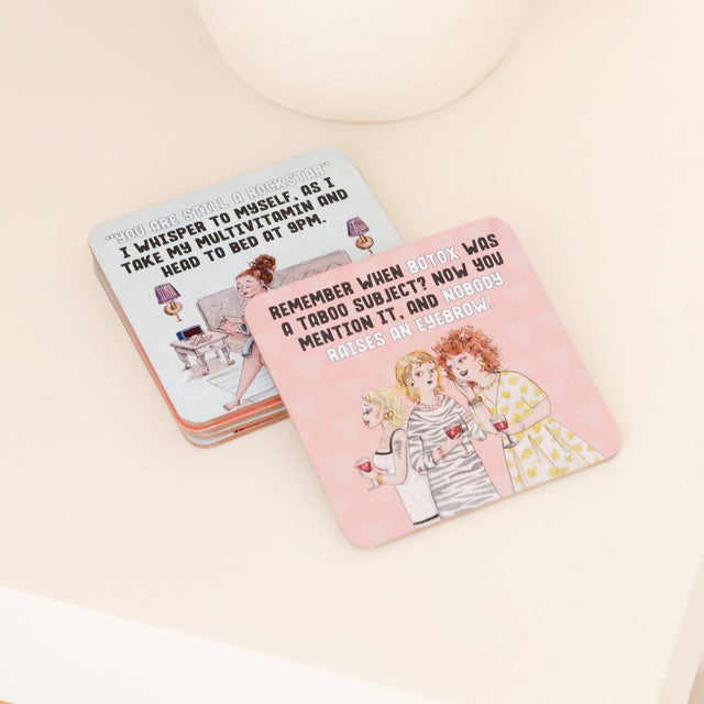 Drinks coasters with illustrated designs and text on a light background
