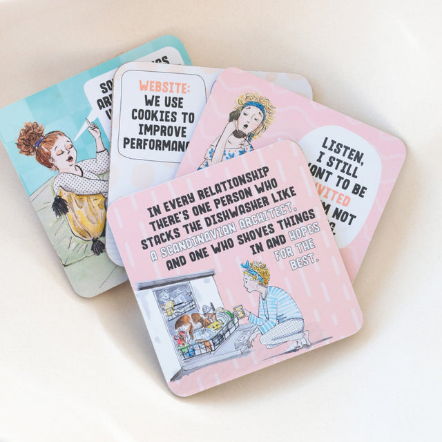 Set of drinks coasters with illustrated characters and humorous text on a light background