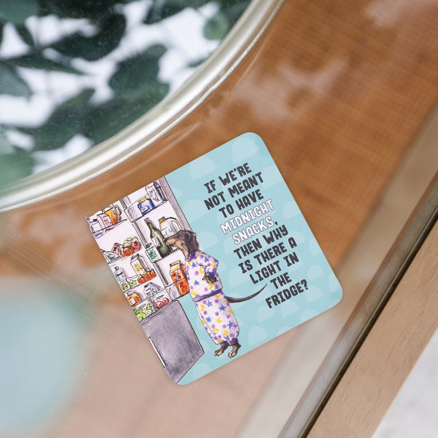 Drinks coasters with illustration of a person looking into a refrigerator and text on a wooden surface.