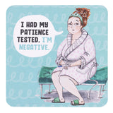 drinks coasters with Illustration of a woman sitting on a bench with a speech bubble saying 'I had my patience tested. I'm negative.'