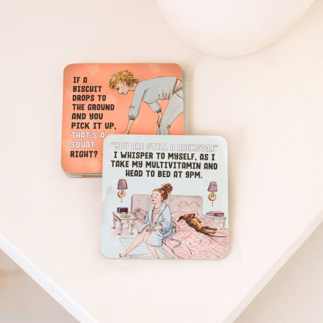 Drinks coasters with humorous illustrations and text on a light background