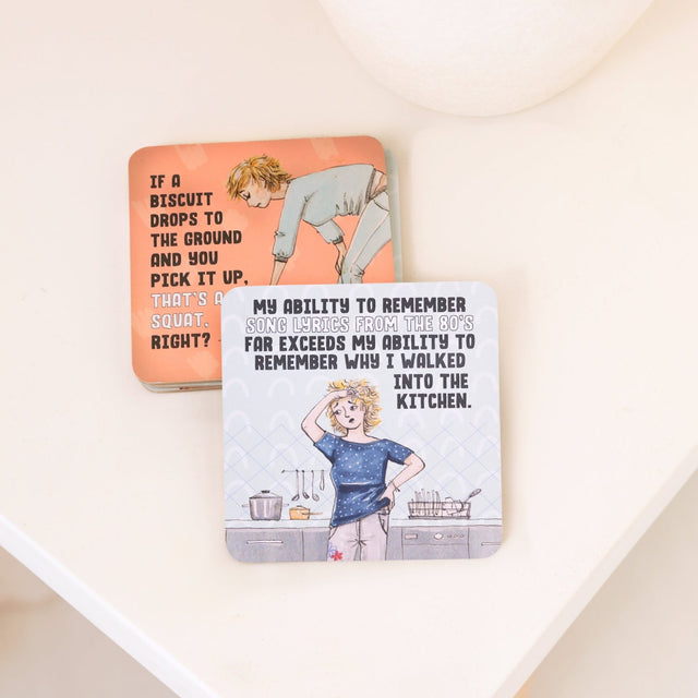 Drinks coasters with humorous illustrations and text on a white surface