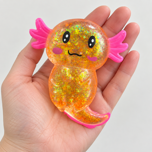 Glitter axolotl sensory squishy toy shown in an adult hand for scale