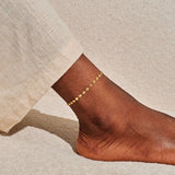 Delicate sparkle chain gold anklet worn on ankle