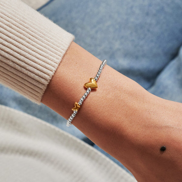 Joma Jewellery April birth month silver and gold-plated bracelet worn on wrist