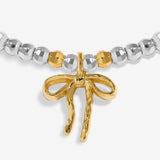 Joma Jewellery Fa La La La La silver and gold-plated bracelet close-up of the gold-plated bow charm